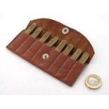 Shooting: A set of 8 - peg brass position finders, in a tan leather case,