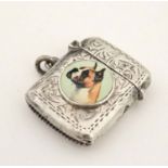 A silver vesta case with later applied 21stC ceramic cabochon with dog decoration.