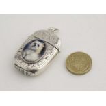 A silver plate vesta case with later applied 21stC ceramic cabochon depicting image of a dog.