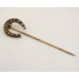 A gilt metal stick pin surmounted by a horseshoe 3" high CONDITION: Please Note -