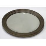 A circular brass framed mirror with bevelled glass CONDITION: Please Note - we do