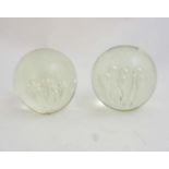 A large pair of clear glass dump paperweights with waterfall bubbles. Each 4 1/2'' diameter.