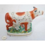 A 21st Century Staffordshire figure of a cow CONDITION: Please Note - we do not