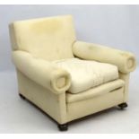 A late Victorian upholstered and overstuffed armchair with walnut bun feet.