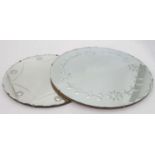 A pair of circular late deco mirrors with floral decoration (20'' diameter and 24'' diameter)
