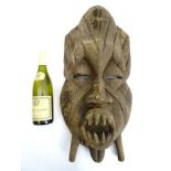 Tribal : An Ethnographic Native Tribal West African mask with bared teeth. Approx. 27" high.