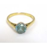 An 18ct gold ring set with aquamarine coloured stone CONDITION: Please Note - we