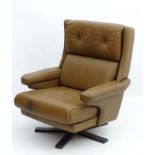 Vintage Retro :A Danish leather swivel armchair , with brown upholstery on a 5 Spoke base ,