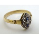 A late 19thC / early 20thC yellow metal ring set with diamonds and blue stones