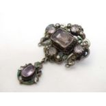 A white metal brooch in the Austro-Hungarian style set with amethysts,