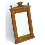 An early 20thC Oak Mirror with shaped pediment having an applied oval disk with floral marquetry