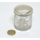 A cut glass dressing table jar with silver top hallmarked Birmingham 1920 maker Boots Pure Drug Co.