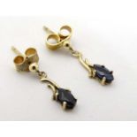 A pair of 9ct gold earrings set with sapphire drops 3/4" long CONDITION: Please