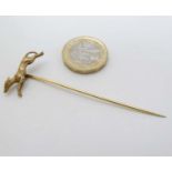 A yellow metal stick pin surmounted by a greyhound / long dog 2 7/8" long CONDITION: