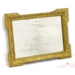 An early 20thC small proportion mirror with gilt foliate surround.