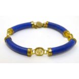 An Oriental gilt metal and lapis Lazuli bracelet with Oriental Character mark decoration.