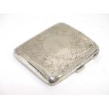 A silver cigarette case of shaped form with engraved decoration.