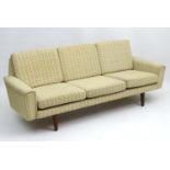 Vintage Retro: A Danish oatmeal woollen upholstered 3 seat Sofa standing on turned legs,