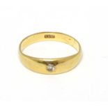 An 18ct gold ring set with central diamond CONDITION: Please Note - we do not make