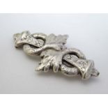 A white metal brooch with engraved acanthus decoration 2 3/4" wide CONDITION: