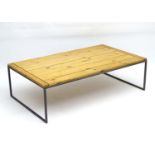 A Jim Lawrence coffee table, having an iron frame and pine top,