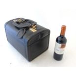 Asprey London ; A black leather vanity case, opening to reveal 10 jar holders,