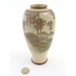 A Japanese Satsuma vase depicting a pagoda garden scene with wisteria decoration along to the top,