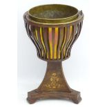 A 19thC Biedermeier jardinière stand with carrying handle, slatted exterior with a brass centre,