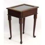 An early 20thC mahogany vitrine standing on four short cabriole legs.