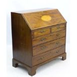 An 18thC Sheraton bureau with decorative stringing throughout, shell marquetry to the front,