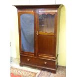 Arts and Crafts : A mahogany and brass strapped double Wardrobe with single bevelled mirror and