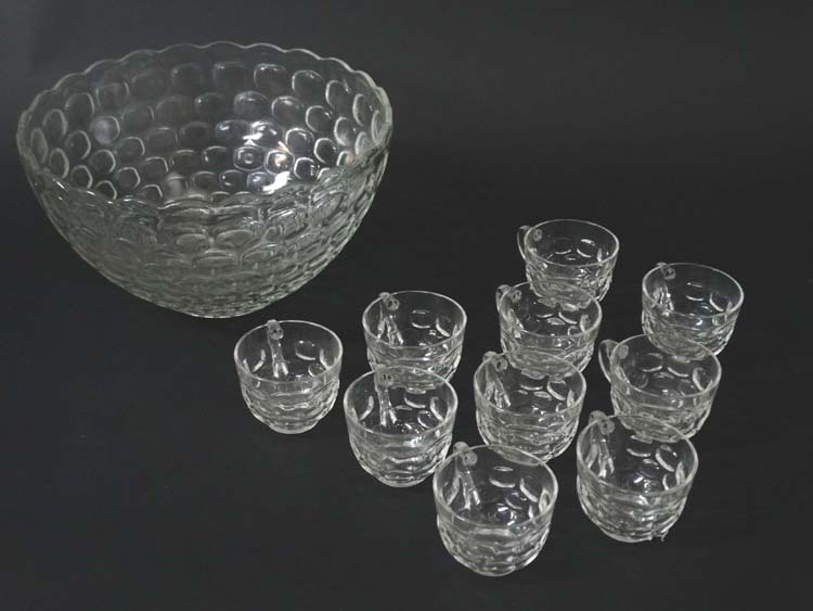 A mid 20thC glass punch bowl with 10 punch cups.