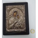 A religious icon with white metal surround CONDITION: Please Note - we do not