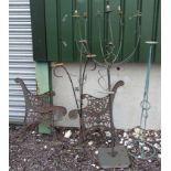 Four garden candelabra and a pair of cast iron bench ends CONDITION: Please Note -