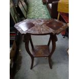 An Art Deco carved occasional table