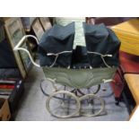 A Silvercross twin dolls pram (coach built)