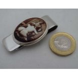 A silver money clip with enamel decoration of a nude female figure CONDITION: