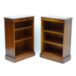 A pair of mid 20thC mahogany bookcases with adjustable shelves and flame mahogany veneered friezes