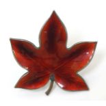 Scandinavian Jewellery : A Danish silver gilt brooch formed as a leaf with red enamel decoration by
