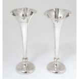 A pair of silver bud vases, hallmarked Birmingham 1910 maker TW.