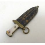 A Victorian unusual cigar cutter formed as a dagger with mother of pearl handle and brass and