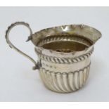 A silver cream jug with fluted decoration hallmarked Birmingham 1891 maker Vale Brothers & Sermon 2