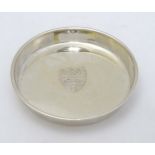 A silver shallow dish of circular form engraved with coat of arms / shield for Cambridge University.