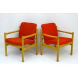 Vintage Retro : a pair of Danish blonde oak open arm chairs with light red woollen upholstery ,