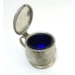 Liberty and co: A planished pewter mustard pot with blue glass liner. Number 1078.