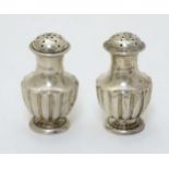 A pair of Victorian silver pepperettes 2 1/4" high (44g) CONDITION: Please Note -