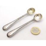 A pair of Victorian silver bead edge salt spoons hallmarked London 1886 maker John Aldwinckle &