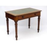 A mid / late 20thC writing desk with single long drawer,