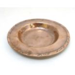 Hugh Wallis : An Arts & Crafts copper dish, with folded rim. Marked under.