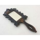 A late 19thC Swiss Black Forest carved wooden hand mirror 12 3/4" long x 5" wide